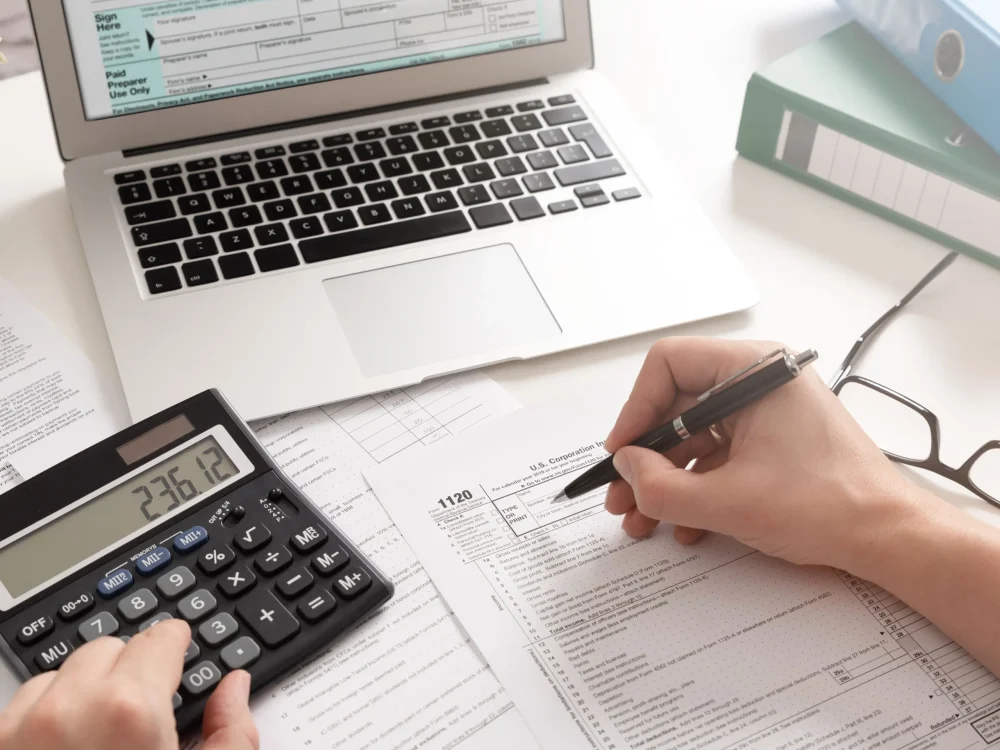 accountant-working-with-us-tax-forms-1096860416-1c02675e418c4e2a9e51495324b2e767